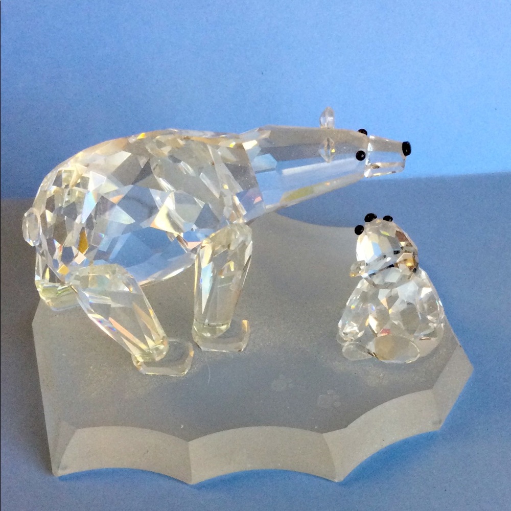 Bear & frog looking at each other on ice slab.